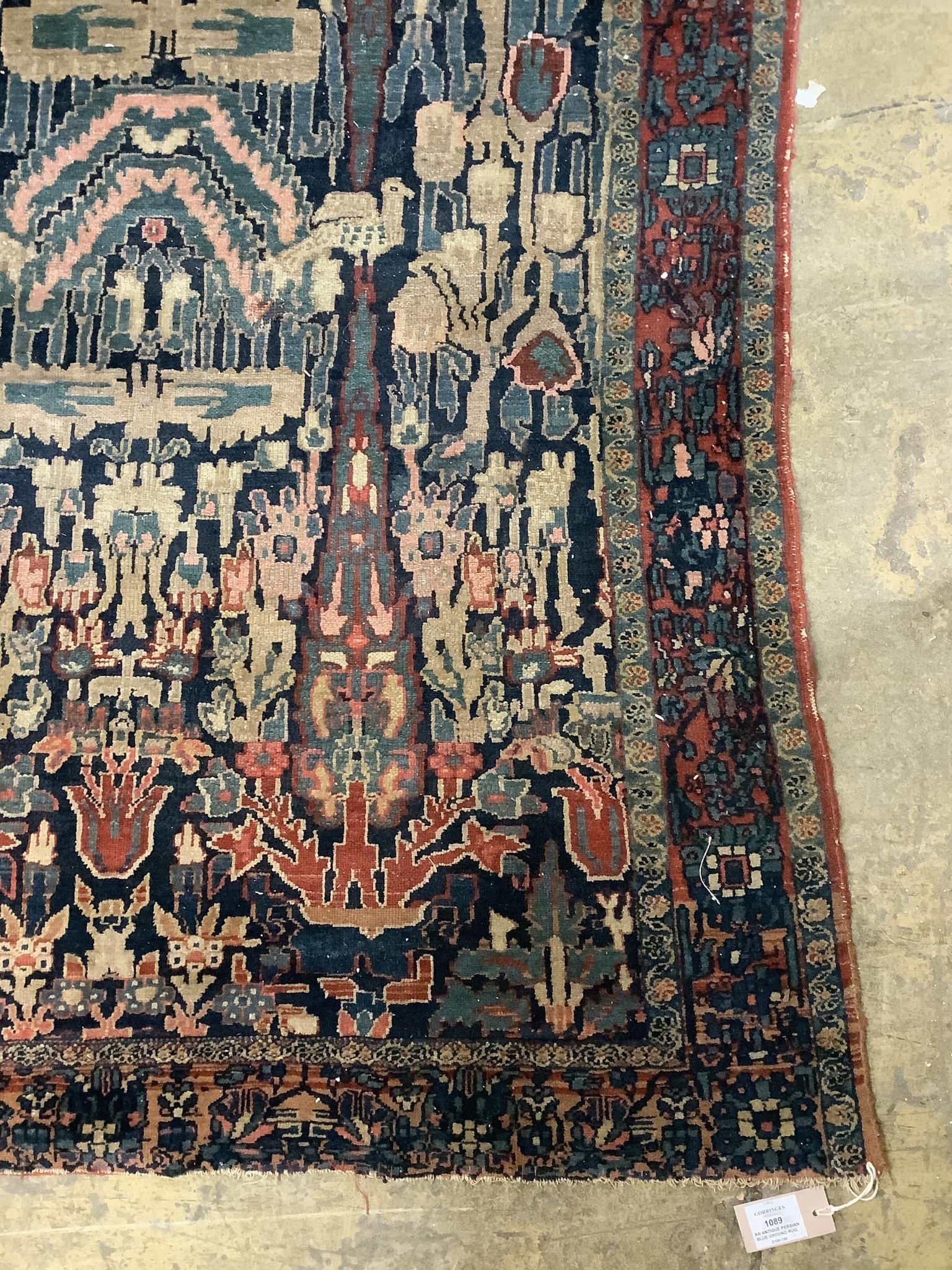 An antique Persian blue ground rug, woven with birds within a garden, 170 x 120cm